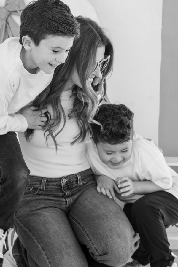 Black and white portrait of mother with two boys