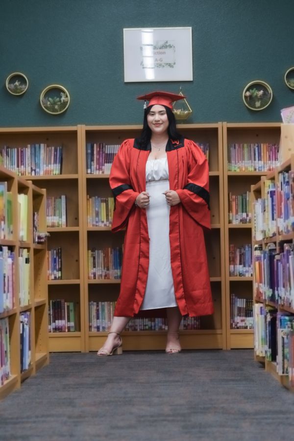 Senior portrait in red cap and gown