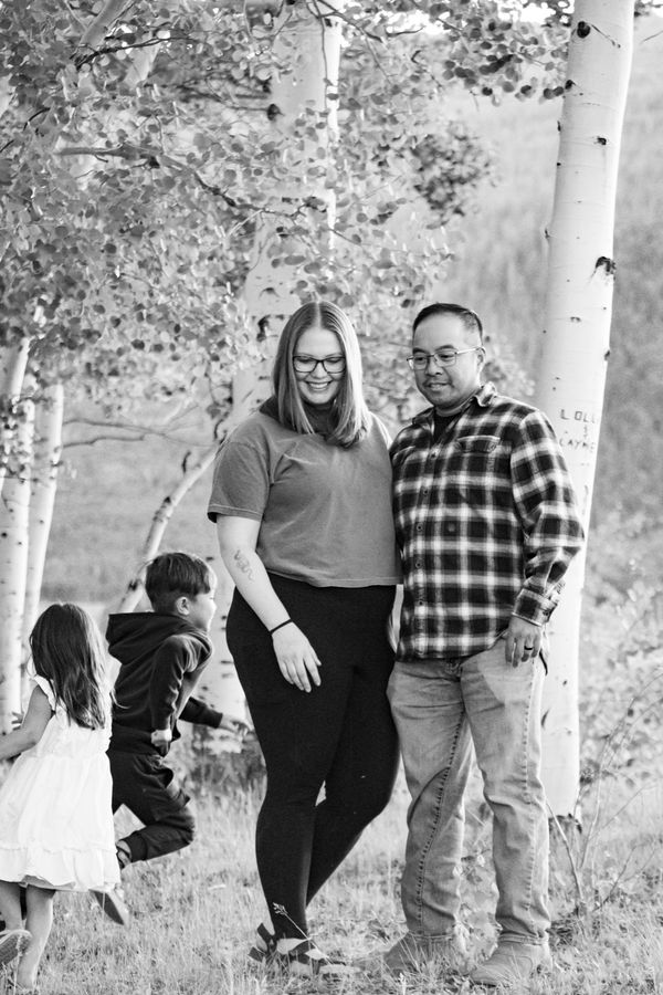Black and white family portrait among birch trees