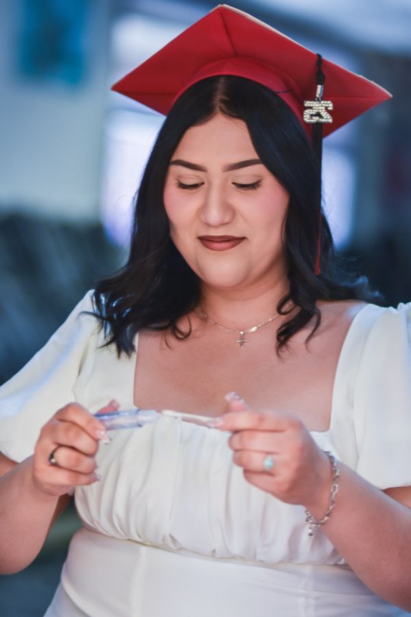 Graduate posing in cap and gown