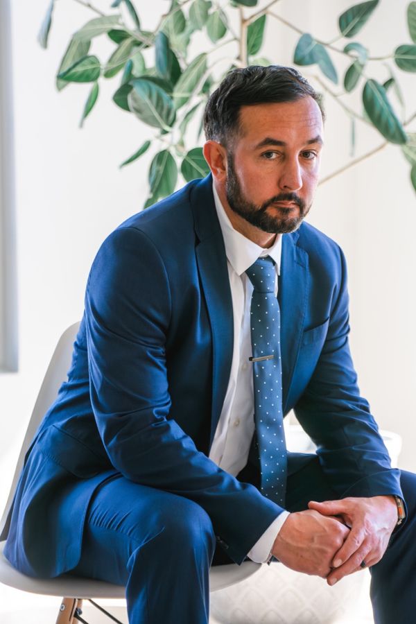 Seated portrait of a man in a blue suit