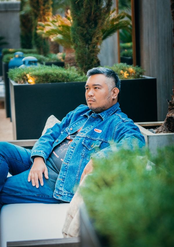 Man in a denim jacket in an urban setting