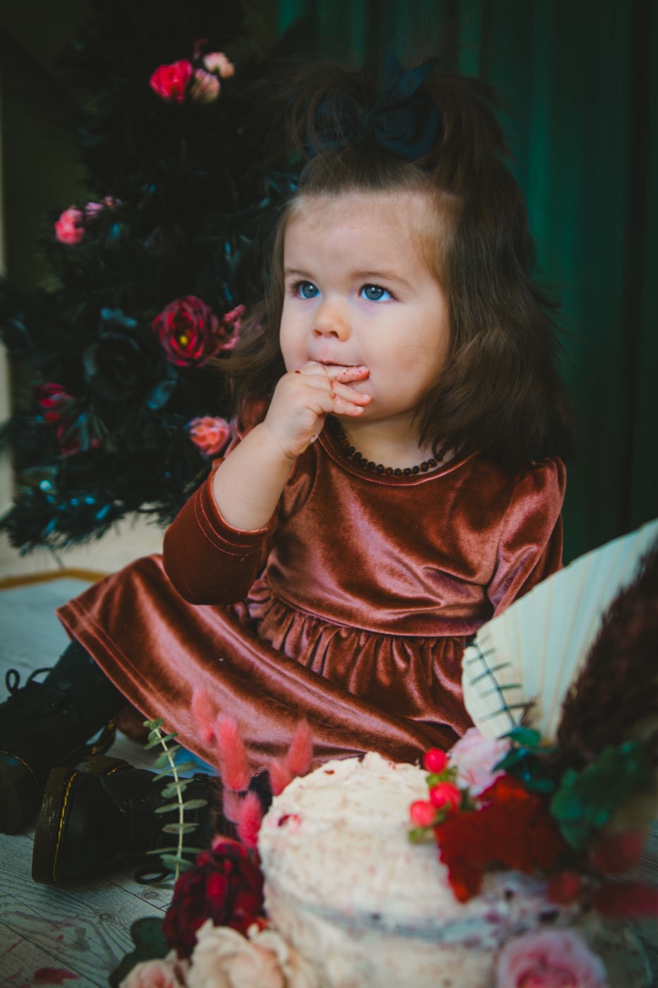 Toddler enjoying a cake smash milestone session